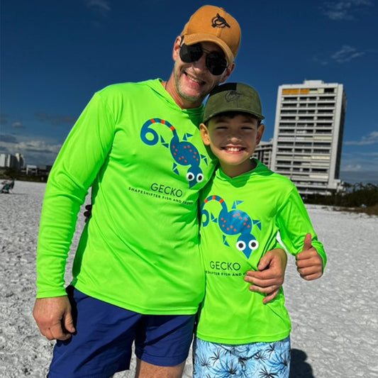 Man and boy wearing Neon Green high visibility Gecko UPF 50+ swim-safe color by ShapeShifter Fish and Friends on the beach lifestyle