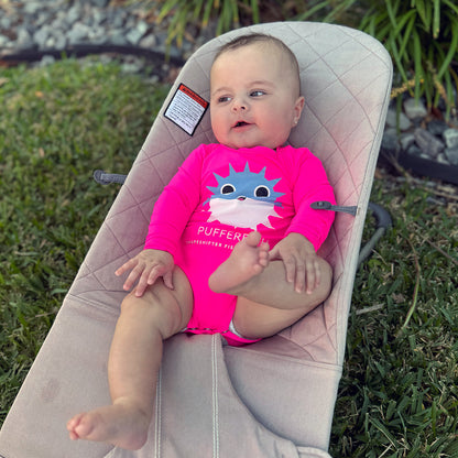 Baby in a Hot Pink Pufferfish Upf50 Sun Protective Baby Onesie UPF 50+ sunwear by ShapeShifter Fish and Friends sitting in a baby bouncer outdoors, lifestyle