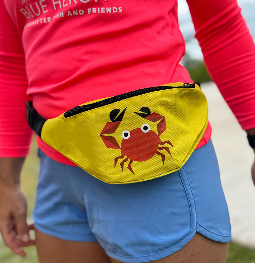 Person wearing a yellow ShapeShifer crab fanny pack