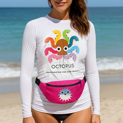 Person wearing a ShapeShifter Fish and Friends white long-sleeve shirt with an octopus design and a pink fanny pack on a beach.