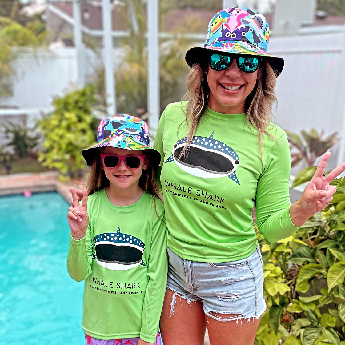 Mom and daughter wearing matching Lime Green Whale Shark Sun Protective Shirts, unbreakable sunglasses, and bucket hats by ShapeShifter Fish and Friends lifestyle