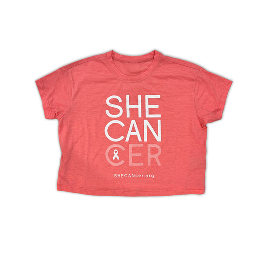 Pink cropped t-shirt with 'SHE CAN CER' text and logo on a white background